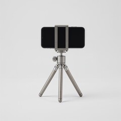 A smartphone on a small metallic tripod. The tripod is positioned centrally, and the smartphone's screen faces away from the camera.  The background is neutral. 