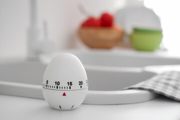 Kitchen timer on counter near sink in room, closeup