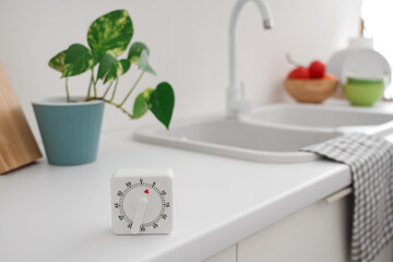 Kitchen timer on counter near sink in room, closeup