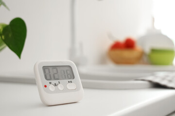 Kitchen timer on counter near sink in room, closeup