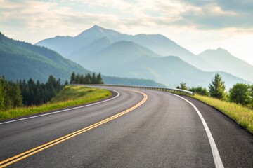 Fototapeta premium Winding road through misty mountains under a cloudy sky 