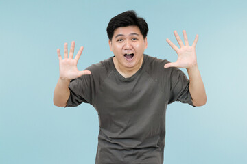 young asian man expressing surprised in studio background