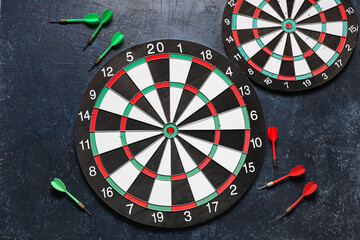 Boards with darts on dark background
