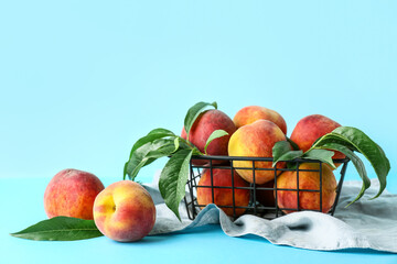 Basket of fresh peaches on blue background
