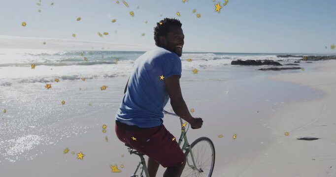 Cyclist pedaling green bike on beach travel sensing behind, turning to smile as yellow stars float