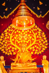 Golden Buddha statue in the chapel of a temple in Thailand