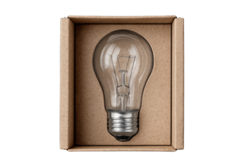 A clear glass lightbulb sits upright in a simple, light brown cardboard box against a black background