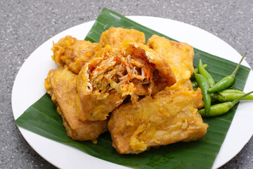 Indonesian street food tahu isi, Fried tofu with spicy vegetables inside and green chili