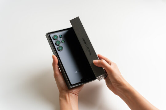 PENANG, MALAYSIA - MAY 29, 2025: Samsung Galaxy S25 Ultra unbox in isolated white background. Hand remove the box cover and reveal the Samsung Galaxy S25 Ultra