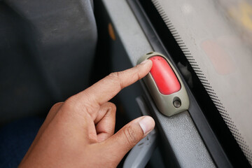 Passenger signals to stop bus with red button