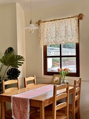 A country-style dining table by the window