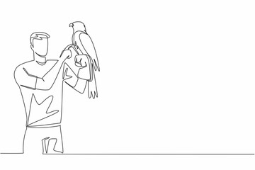 Single one line drawing eagle perched on hand of man. One of many large, thick billed, large footed birds of prey. Strong talons. Claws. Man Holding Bird. Continuous line design graphic illustration