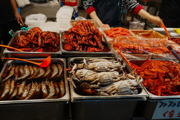 Vibrant Korean Seafood Delicacies: Marinated Crabs, Shrimp, and Kimchi at Gwangjang Market, Seoul