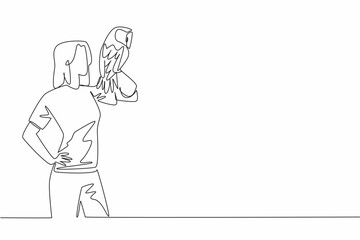 Single one line drawing tawny owl perched on hand of woman. Medium sized owl that lives in England. One of the favorite animals to keep. Woman Holding Bird. Continuous line design graphic illustration