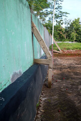 Weathered Green Wall with Concrete Supports