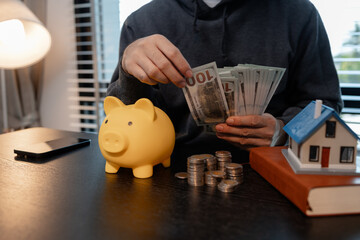 a man uses his savings to buy his dream home, this man plans his finances to buy a home, he uses...