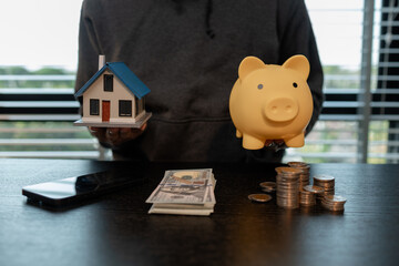 a man uses his savings to buy his dream home, this man plans his finances to buy a home, he uses...