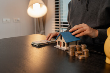 a man uses his savings to buy his dream home, this man plans his finances to buy a home, he uses...
