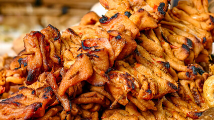 A close-up of delicious grilled chicken intestine satay, showcasing its mouth-watering texture and flavor. Indonesian cuisine