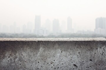 Hazy cityscape viewed from a textured concrete ledge