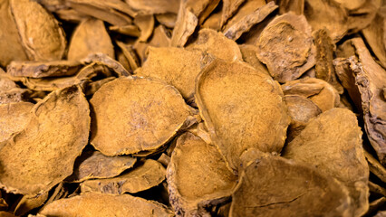 Detailed close up of dried turmeric slices revealing texture and earthy tones