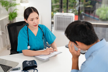 Male patient with terrible headache visiting his doctor. Young man suffering from migraine in...