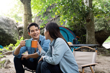 Camping Couple Sharing a Moment with Hot Drinks in Nature