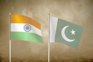 India and Pakistan flags with an inferno landscape background. Pakistan vs India military war conflict. Weapon of a nuclear missile battle