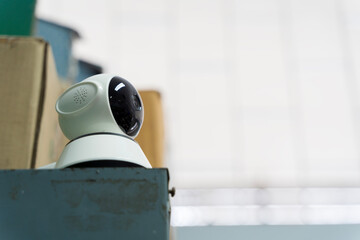 Indoor surveillance camera placed on shelf for security monitoring in smart home or office environment system