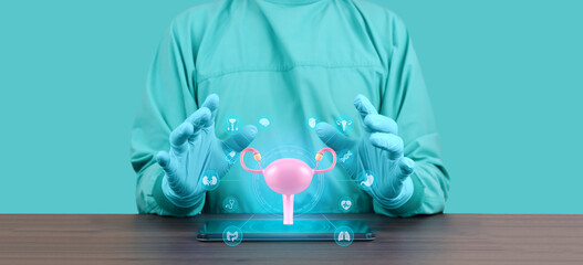 Gynecologist with tablet showing an anatomical model and 3D hologram of the uterus and ovaries. Women's health, prevention, pap smear, diagnosis, and medical technology. Emerald green.