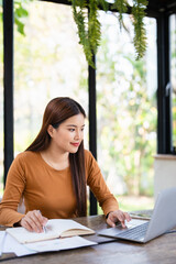 Computer and papers. Focused asian woman office worker Entrepreneur freelancer do paperwork manage...