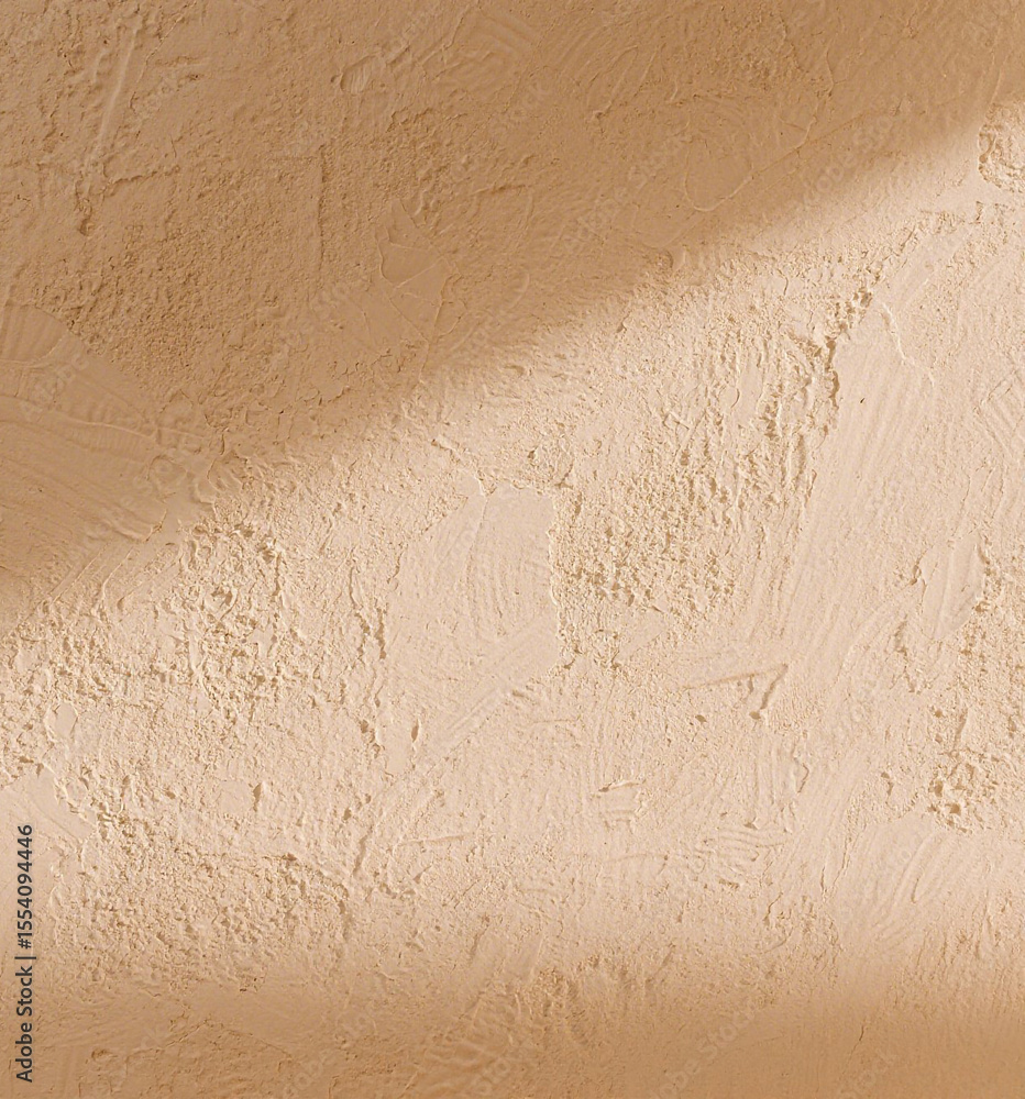 Poster beige textured wall with a diagonal shadow creating a warm backdrop