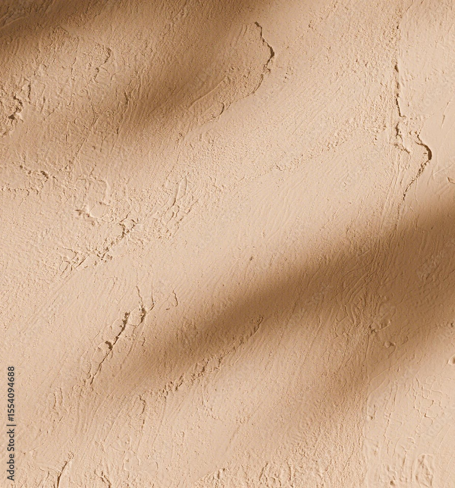 Poster beige textured wall with a diagonal shadow creating depth and interest