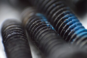 The fine threads of the screws, along with the metallic sheen and texture