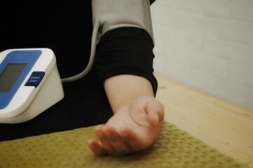 A person is using blood pressure monitor