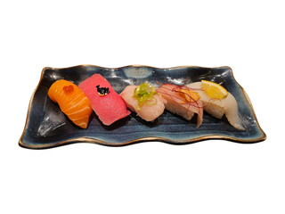Colorful nigiri sushi set displayed on artistic blue plate, great for Japanese food visuals, menu...