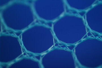 Close-up of a blue hexagonal mesh pattern, showcasing intricate, interwoven strands