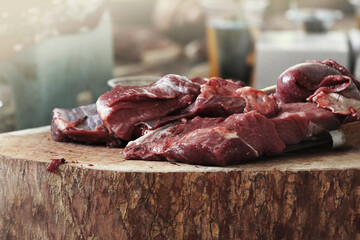 Fresh raw beef slices on a wooden cutting board