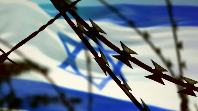 Flag of Israel behind a barbed wire