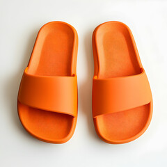 A cute pair of orange pillow slide sandals, placed neatly on a clean white background