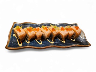 Sushi rolls with grilled topping lined up on ceramic plate, ideal for restaurant ads, Asian food content, or takeaway menu visuals. Isolated on white background