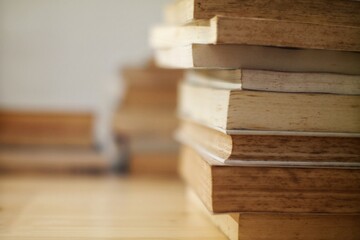 SAMSUNG CSCClose-up of a stack of aged books on a wooden surface with a blurred background, conveying a vintage and educational theme ideal for learning and reading concepts