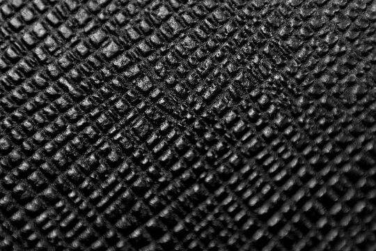 The image offers a detailed, sharp close-up of a black, textured material. Its abstract and high-contrast nature makes it ideal for backgrounds and design elements