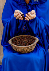 April 1, 2024 Dubai, UAE. Hands of a woman sorting through spices at a local market.