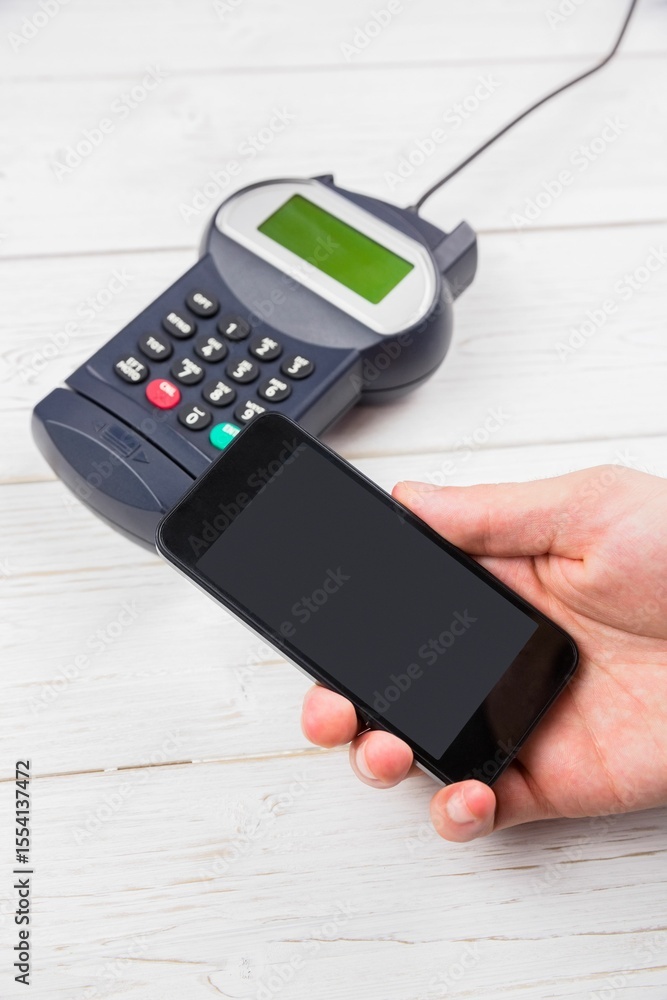Poster flat design showing smartphone hovering above card reader on white tabletop for contactless payment