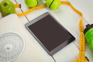 High angle view of digital tablet and tape measure on table