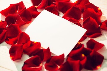 Card surrounded by rose petals