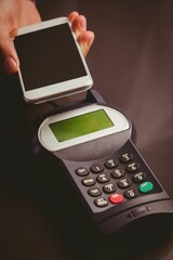 Man using smartphone to express pay