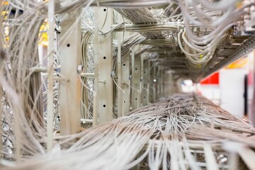 Flat design is showing dense assembly of unshielded data cables on metal rack structure