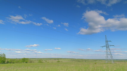 A Beautiful Scenic Open Field Adorned with Power Lines and Dramatic Clouds in the Sky Time lapse.